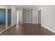 Open-concept living room showcasing hardwood floors, wallpaper, and access to the screened deck at 4009 Banks Stone Dr, Raleigh, NC 27603