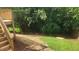 A spacious backyard area with a wooden deck, lush trees, and green grass at 4319 White Cliff Ln, Durham, NC 27712