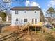 View of the backyard featuring a spacious wooden deck accessible through double doors, perfect for outdoor entertaining at 4319 White Cliff Ln, Durham, NC 27712