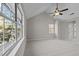 Spacious bedroom with a high ceiling, large windows, and a ceiling fan at 4319 White Cliff Ln, Durham, NC 27712