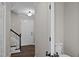 Welcoming foyer with hardwood floors, a staircase, and a half bathroom, creating an inviting entry at 4319 White Cliff Ln, Durham, NC 27712