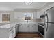 Bright kitchen with white cabinetry, modern stainless steel appliances, and wood flooring at 4319 White Cliff Ln, Durham, NC 27712