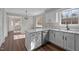 Updated kitchen featuring white cabinets, stainless steel dishwasher, and wood flooring at 4319 White Cliff Ln, Durham, NC 27712