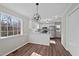 Eat-in kitchen featuring stainless steel appliances, white cabinets, and contemporary light fixture at 4319 White Cliff Ln, Durham, NC 27712