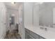 Bathroom features a long vanity with grey cabinets, white counter, sink, faucet, and a large mirror at 501 Historic Dr, Hillsborough, NC 27278