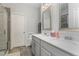 Bright bathroom with double sink vanity, quartz countertop, neutral cabinets and flooring, and framed mirrors at 501 Historic Dr, Hillsborough, NC 27278