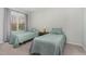 Bright bedroom featuring two twin beds with quilted bedspreads and a large window with curtains at 501 Historic Dr, Hillsborough, NC 27278