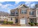 Charming two-story townhome with brick and siding, attached garage and well-manicured landscaping at 501 Historic Dr, Hillsborough, NC 27278