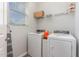 Functional laundry room with washer, dryer, wire rack shelving and natural light at 501 Historic Dr, Hillsborough, NC 27278