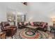Open concept living area with leather seating, decorative rug and view to the modern kitchen at 501 Historic Dr, Hillsborough, NC 27278