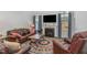 Cozy living room with a fireplace, comfortable leather furniture, and lots of natural light at 501 Historic Dr, Hillsborough, NC 27278