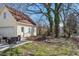 Exterior view of home featuring the backyard, a patio set and several trees at 506 W Gilbreath St, Graham, NC 27253