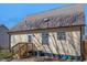 Exterior view of home showing metal roof, siding, and backyard with trees at 506 W Gilbreath St, Graham, NC 27253