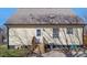 Exterior view of home featuring metal roof, siding, a backyard and set of wooden stairs at 506 W Gilbreath St, Graham, NC 27253