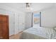 Bright bedroom with a ceiling fan, a window with blinds and curtains, and a closet for storage at 506 W Gilbreath St, Graham, NC 27253