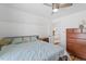 Bedroom with white walls, ceiling fan and drawers for storage, illuminated by natural light at 506 W Gilbreath St, Graham, NC 27253