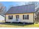 Charming home features a new metal roof and yellow siding at 506 W Gilbreath St, Graham, NC 27253
