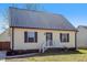 Charming home exterior featuring siding, a metal roof, a porch, and green grass at 506 W Gilbreath St, Graham, NC 27253