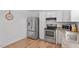 Well-lit kitchen featuring stainless steel appliances and granite countertops at 506 W Gilbreath St, Graham, NC 27253