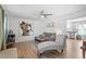 Bright living room with hardwood floors, modern ceiling fan, and gray furniture at 506 W Gilbreath St, Graham, NC 27253