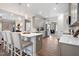 Bright kitchen with gray cabinets, quartz countertops, stainless steel appliances, and an eat-in island perfect for modern living at 508 Olivia Crossing Ct # 17, Four Oaks, NC 27524
