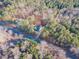 Scenic aerial view of a home nestled among dense trees, showcasing its location and surrounding landscape at 5171 S River Rd, Lillington, NC 27546