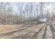The backyard features a shed, a partially wooded area, and space for outdoor activities at 5171 S River Rd, Lillington, NC 27546