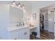 Bathroom featuring vanity with lighted mirror and walk-in closet at 5171 S River Rd, Lillington, NC 27546