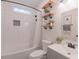 Bathroom featuring a tub with subway tile surround, open shelving, and modern fixtures at 5171 S River Rd, Lillington, NC 27546