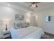 Bedroom features a ceiling fan, windows, and side table lamps at 5171 S River Rd, Lillington, NC 27546