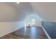 Spacious bonus room with hardwood floors, natural light, and a cozy seating area at 5171 S River Rd, Lillington, NC 27546