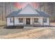 Charming one-story home featuring a welcoming front porch and a well-maintained yard at 5171 S River Rd, Lillington, NC 27546