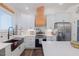 Modern kitchen featuring white cabinets, quartz countertops, and a stainless steel refrigerator at 5171 S River Rd, Lillington, NC 27546