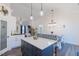 Open concept kitchen and dining area with stylish island, farmhouse dining table, and modern decor at 5171 S River Rd, Lillington, NC 27546