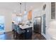 Well-lit kitchen with island seating, stainless steel appliances, pantry, and access to outdoor patio at 5171 S River Rd, Lillington, NC 27546