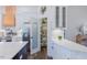 Kitchen with stainless steel appliances, white cabinets, and a walk-in pantry with glass door at 5171 S River Rd, Lillington, NC 27546
