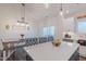 Kitchen and dining area featuring a large island with seating and rustic dining table at 5171 S River Rd, Lillington, NC 27546