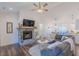Cozy living space with a stone fireplace, vaulted ceiling, and views of the dining area at 5171 S River Rd, Lillington, NC 27546