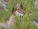 An aerial view of a home nestled among lush trees, providing privacy and a natural setting at 5309 Shoreline Ct, Holly Springs, NC 27540
