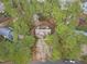 Birds-eye view of home surrounded by mature trees offering seclusion and natural beauty at 5309 Shoreline Ct, Holly Springs, NC 27540