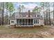 Expansive backyard featuring a screened porch, a cozy deck, and a serene view at 5309 Shoreline Ct, Holly Springs, NC 27540