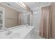 Bathroom with a dual sink vanity, large mirror, neutral walls and shower-tub combo at 5309 Shoreline Ct, Holly Springs, NC 27540