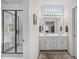 Bathroom featuring a dual vanity with white cabinets, a large mirror, and a glass enclosed shower at 5309 Shoreline Ct, Holly Springs, NC 27540