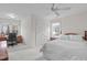 Bright bedroom features neutral walls, natural light, a ceiling fan, and a closet at 5309 Shoreline Ct, Holly Springs, NC 27540