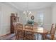 Elegant dining room featuring classic wood furniture, chandelier, and view windows at 5309 Shoreline Ct, Holly Springs, NC 27540