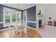 Eat-in kitchen nook with hardwood floors, dining table, view windows, and fireplace at 5309 Shoreline Ct, Holly Springs, NC 27540