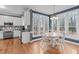 Eat-in kitchen nook with hardwood floors, dining table, and oversized view windows at 5309 Shoreline Ct, Holly Springs, NC 27540