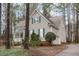 This beautiful home features a side-entry garage and mature landscaping for enhanced curb appeal and privacy at 5309 Shoreline Ct, Holly Springs, NC 27540