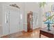 Bright foyer with hardwood floors, high ceilings, and a classic grandfather clock at 5309 Shoreline Ct, Holly Springs, NC 27540