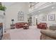 Large living room with high ceilings, fireplace, and ample seating for entertaining at 5309 Shoreline Ct, Holly Springs, NC 27540